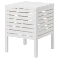 a white wooden side table with lattice design