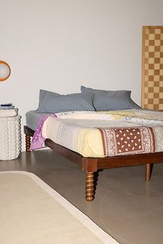 a bed sitting on top of a hard wood floor