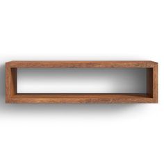 an empty wooden shelf against a white wall