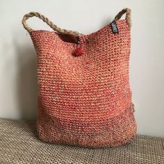 "Handmade crochet bag of natural materials. Great as shopping bag, festival bag, summer beach bag. Material: Linen Main colours: orange Colouring: red/beige/yellow/blue Sizes: Height handle 54 cm - 21\" Height 36 cm - 14\" Width 32 cm - 12.5\"" Beige Crochet Beach Bag, Fair Trade, Fair Trade Beige Crochet Bag For Beach, Beige Fair Trade Crochet Bag For Beach, Beige Fair Trade Crochet Beach Bag, Handmade Orange Beach Bag For Summer, Bohemian Red Woven Straw Bag, Crochet Natural Hobo Bag For Beach, Fair Trade Jute Crochet Bag For Beach, Fair Trade Crochet Beach Bag