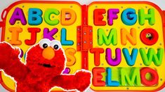 an elmo book with the letters and numbers in sesame's abc, m, l