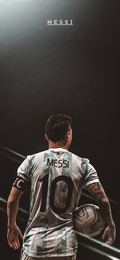 a man holding a soccer ball in front of a black background with the words messi on it