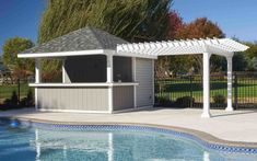 a gazebo next to a swimming pool with a grill on the side and an awning over it