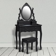 a small black vanity with mirror and stool