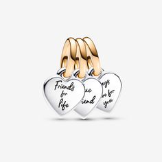 Show them that they mean the world to you with the Pandora Two-tone Splittable Friendship Triple Dangle Charm. Nothing says best friends forever like gifting your besties one part of a splittable charm. Engraved with the messages "Friends for life", "True Friend" and "Always there for you" on each of the hearts, the triple dangle friendship charm is crafted in sterling silver and its bail is in our 14k gold-plated unique metal blend. The two of the pieces are flat on one side and domed on the other, so when placed together, they create a 3D heart shape. Great friends are hard to find, so celebrate yours with a special friendship jewelry piece that represents your bond. - Pandora Two-tone Splittable Friendship Triple Dangle Charm - Sterling silver and 14k Gold-plated unique metal blend Friends For Life, Friendship Jewelry, 3d Heart, Fine Jewelry Bracelets, Pandora Bracelets, Best Friends Forever, Dangle Charms, Pandora Bracelet, True Friends