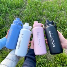 four people holding water bottles in their hands with the words united kingdom printed on them