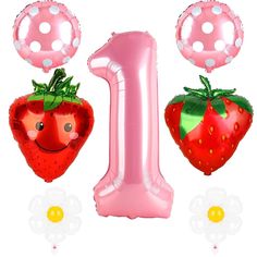 an inflatable number one balloon and two strawberry balloons