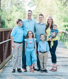 a family poses for a photo on a bridge