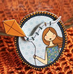 a close up of a paper doll holding a kite