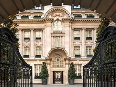 the entrance to an ornate building with wrought iron gates and gated entry way leading into it