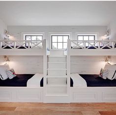 two white bunk beds sitting next to each other