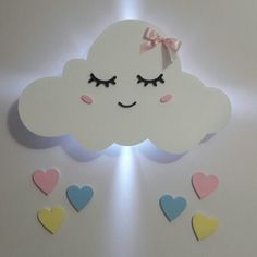 a white cloud with hearts on it and a pink bow hanging from the ceiling above