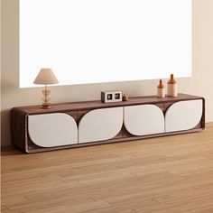 a white and brown entertainment center with two lamps on each side by the wall in front of it