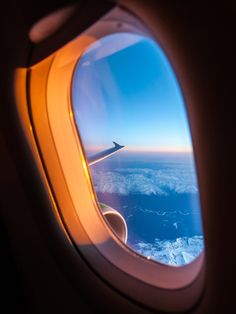 an airplane window looking out at the ocean