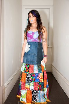 a woman standing in a hallway wearing a colorful dress