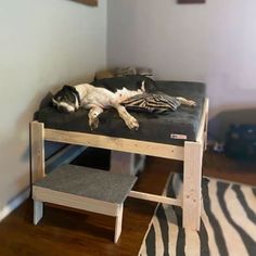 a dog laying on top of a bed in a room