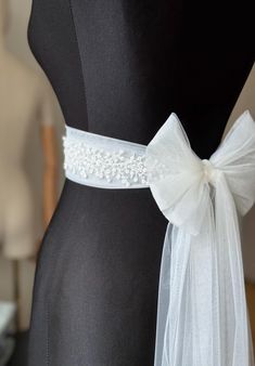 A stunning, elegant statement wedding sash is exquisitely beaded in beautiful vintage pattern. Your choice tulle  sash is attached to the beading and ties at the back into a bow.  An ultimate luxurious accent piece for your wedding dress or for any special occasion dresses. Accentuate your waist and add a touch of feminine charm to any dress with this tulle sash. Even the most simple gown can transform into a dreamy ensemble with this voluminous bow. Color embroidery - ivory or white Color tulle may be different  - white, ivory... and other Bead embroidery length 50 cm The belt is made as a long ribbon that you can tie around your waist. Belt For Wedding Dress Bridal Sash, Embroidery Belt For Gown, Belt For Gown Dress, Wedding Bridal Accessories, Satin Ribbon Belt, Simple Wedding Dress Accessories, Belted Wedding Dress, Belt Dress Wedding, Wedding Dress Belts And Sashes