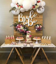 a table topped with cake and balloons next to a wooden sign that says be safe