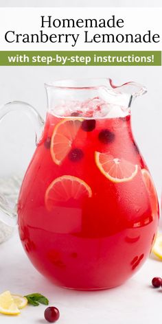 a pitcher filled with cranberry lemonade and garnished with orange slices