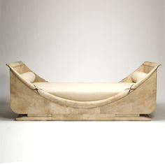 a white couch sitting on top of a wooden stand