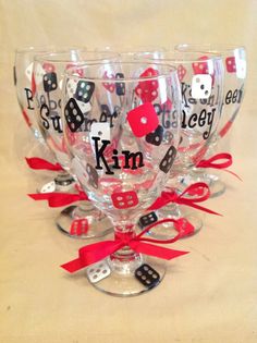 four wine glasses decorated with dice and ribbon