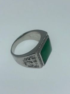 Large green nephrite jade Ornate German Silver Vintage ring, does not tarnish, NOT sterling Has Chinese lettering for luck on the sides. Sizes 8, 9 10 or 11 All rings are shipped in a nice gift box. Check out our over a THOUSAND great reviews Engraving is $4 per letter and is not always perfect depending on the piece. It can take a few days if the jeweler is busy. This is payable to Paypal Judithsltd@gmail.com Classic Green Signet Ring Stamped 925, Green Emerald Cut Signet Ring With Polished Finish, Green Emerald-cut Signet Ring With Polished Finish, Green Rectangular Signet Ring For Formal Occasions, Green Signet Ring For May Birthstone Occasions, Green Signet Ring For May Birthstone Formal Occasions, Classic Green Signet Ring For Gift, Classic Green Engraved Jewelry, Vintage Green Signet Ring With Polished Finish