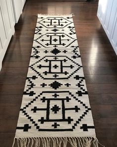 a long black and white rug on the floor