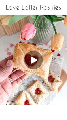 a person holding a piece of food in their hand with the words love letter pastries on it