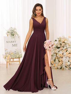 a bridesmaid in a deep purple gown with thigh high slits and a low v - neckline