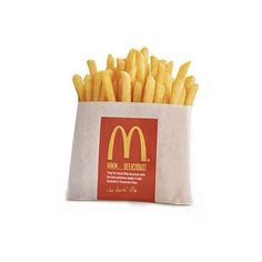 french fries are in a paper bag on a white surface, with the logo mcdonald's