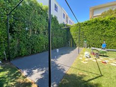 the back yard is fenced off and ready to be used as a tennis court