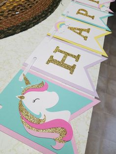 unicorn banner with gold glitter on it sitting on top of a table