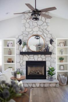 a living room filled with furniture and a fire place in front of a stone fireplace