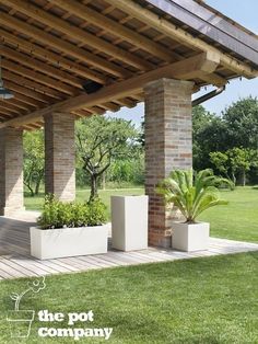 an outdoor covered patio with two planters