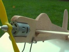 a wooden toy airplane sitting on top of a table