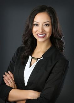 a smiling woman with her arms crossed