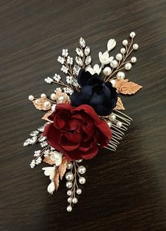 a close up of a hair comb with flowers and leaves on it's side