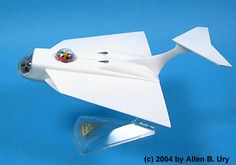 a white model airplane on a blue background