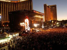 a large crowd is gathered in front of the las vegas strip