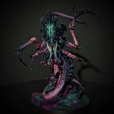 a painted warhammer with purple and green paint on it's body, arms and legs