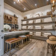 the inside of a shoe store with lots of shoes on shelves and stools in front of them