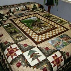 a bed with a quilt on top of it next to a potted green plant