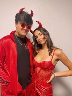 a man and woman dressed up in devil costumes