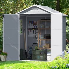 a garden shed with tools and gardening supplies in the storage area on the side of it