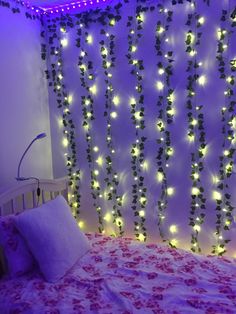 there is a bed that has some lights on the headboard and wall behind it