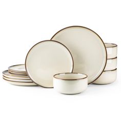 white dishes with gold rims are stacked on top of each other in this image