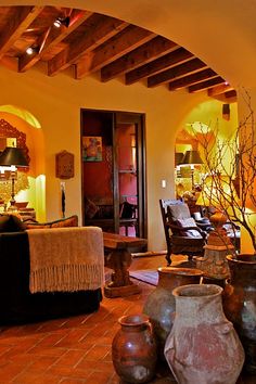 a living room filled with lots of furniture and vases