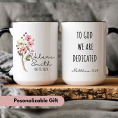 two coffee mugs sitting on top of a wooden table