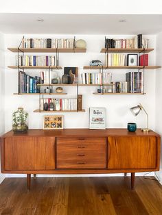 the bookshelves are filled with many different types of books and vases on them