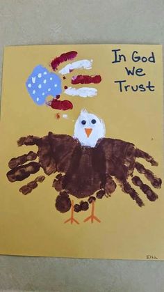 a child's handprint with an eagle on it and the words in god we trust